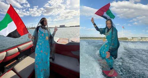 Dubai athlete surfs in traditional Emirati attire, pays